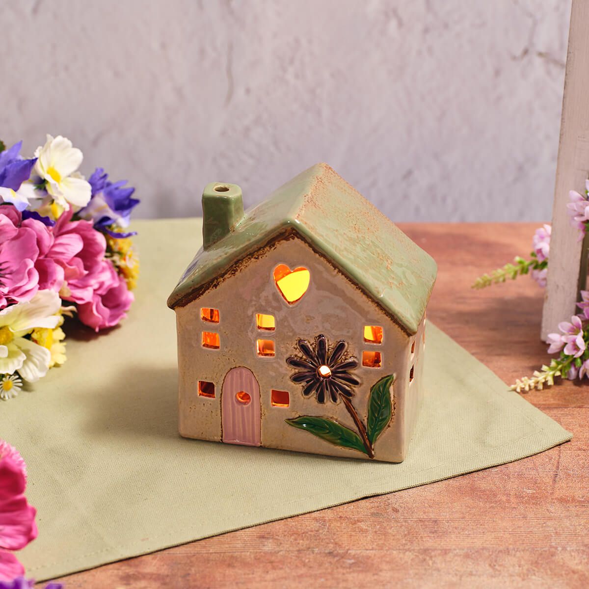 Shabbyquins stoneware house-shaped candle holders with a rustic, textured finish, suitable for decorative and ambient lighting.