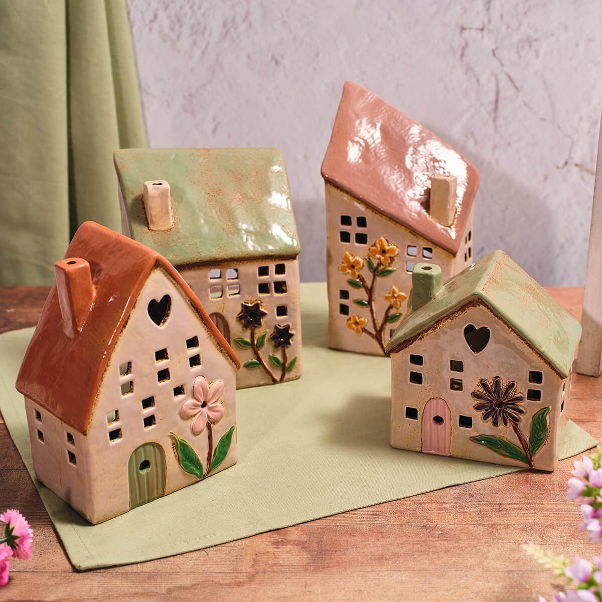 Shabbyquins stoneware house-shaped candle holders on a wooden surface, featuring rustic design and neutral colors.