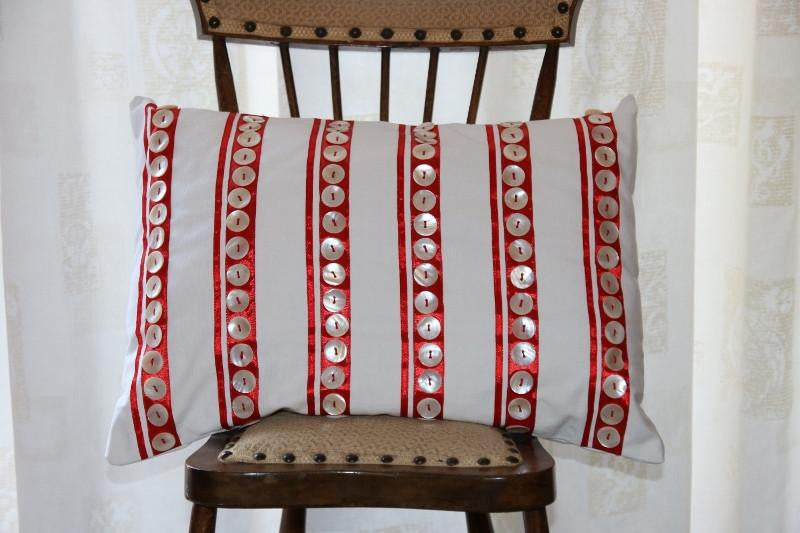 White buttons on red stripes cushion